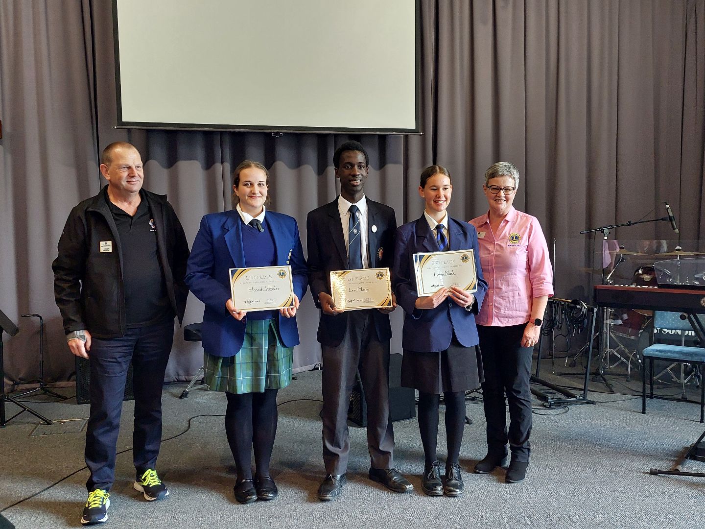 202M FVDG Ron Wezenbeek, 3rd placegetter Hannah Webster, 1st placegetter Leo Mwape, 2nd placegetter Lydia Black, PDG Pam Fiveash.jpg